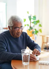 Older man taking pills